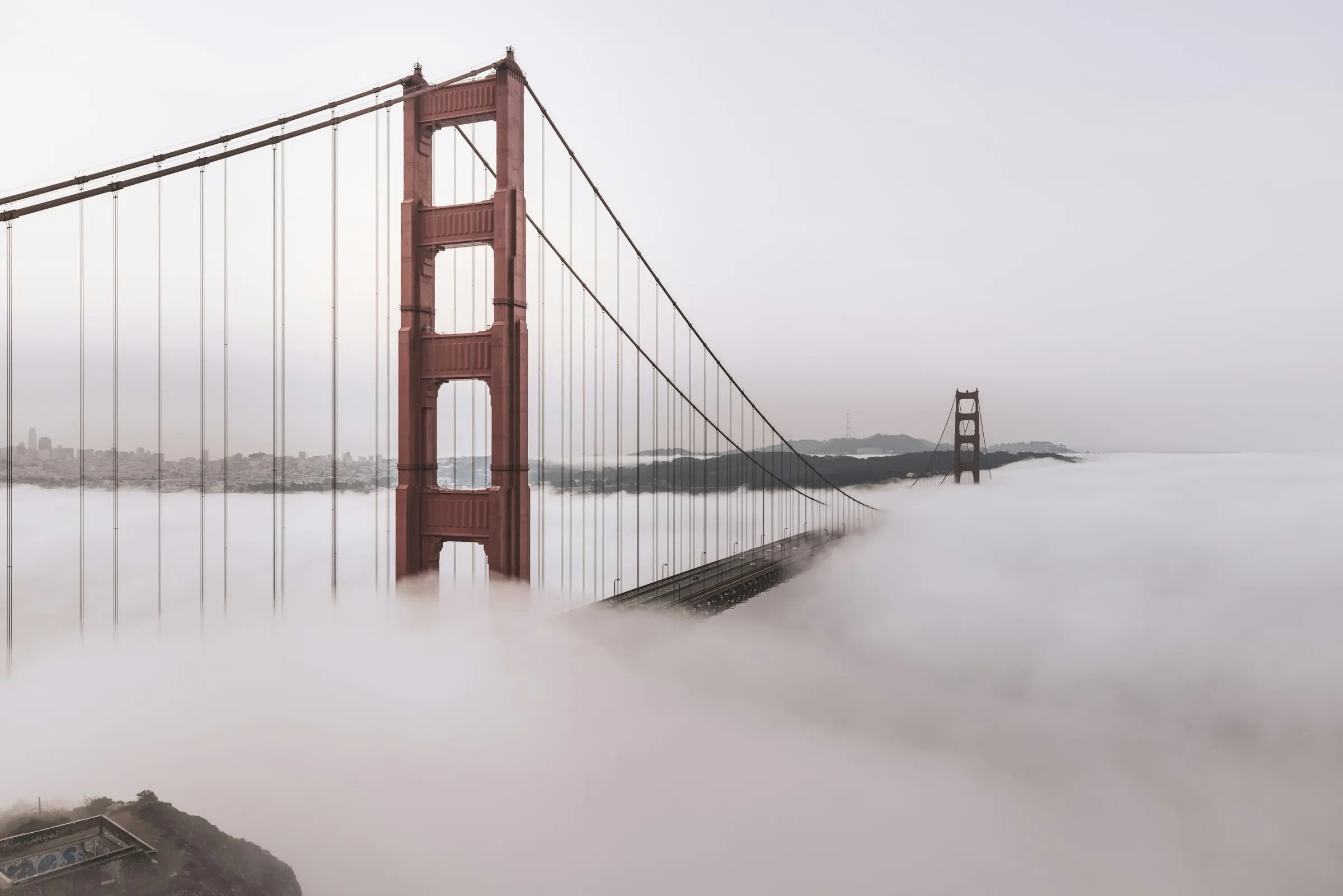 The Golden Gate Bridge rising above fog